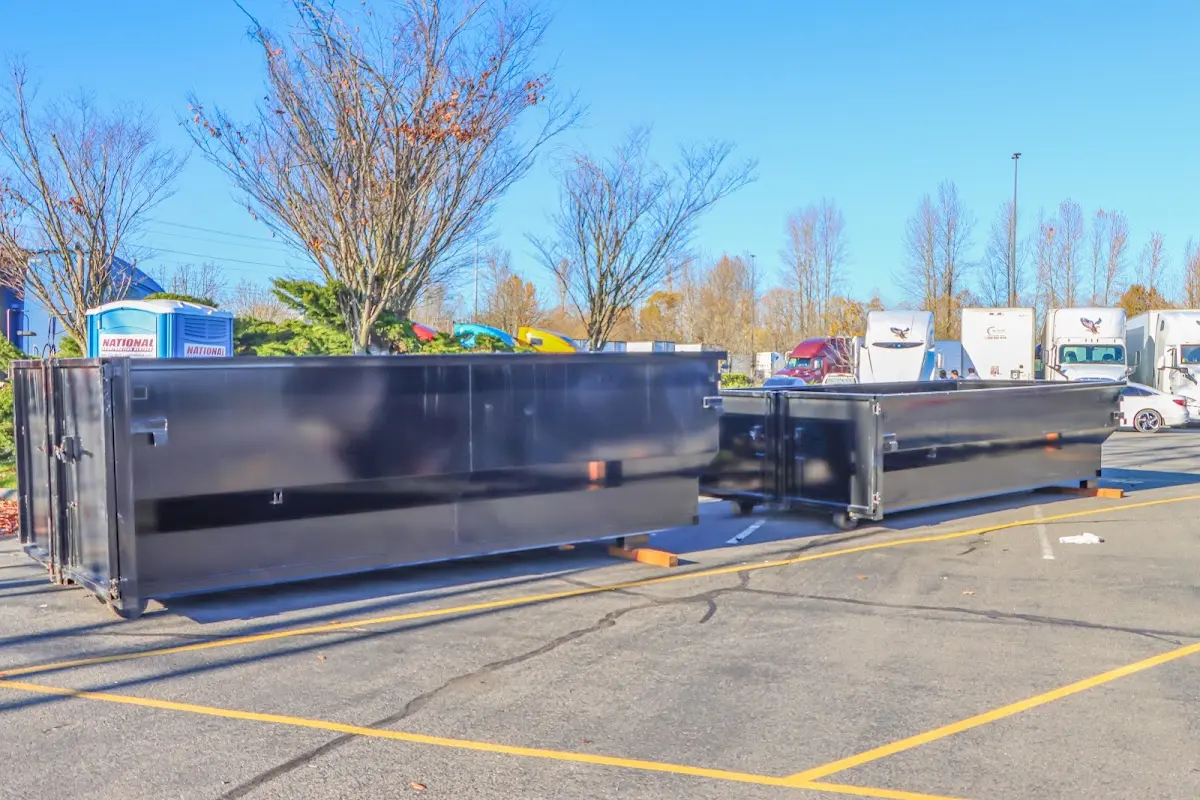 Professional dumpster rental service with roll-off container on residential driveway in Port Sheldon